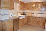 Bespoke Pippy Oak Shaker style kitchen, glass display unit with glass shelves, Quartz worktops, stainless steel appliances and Belfast sink. Gallery Thumbnail