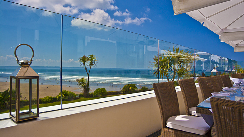 Glass windbreak held securely in place by Pure Vista balustrade. This amazing Devon location has benefitted from keeping the ocean view for their customers.  Gallery Image