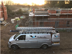 Black seamless aluminium gutter and pipe to new build properties on a development in Stanstead Mountfitchett.  Gallery Thumbnail