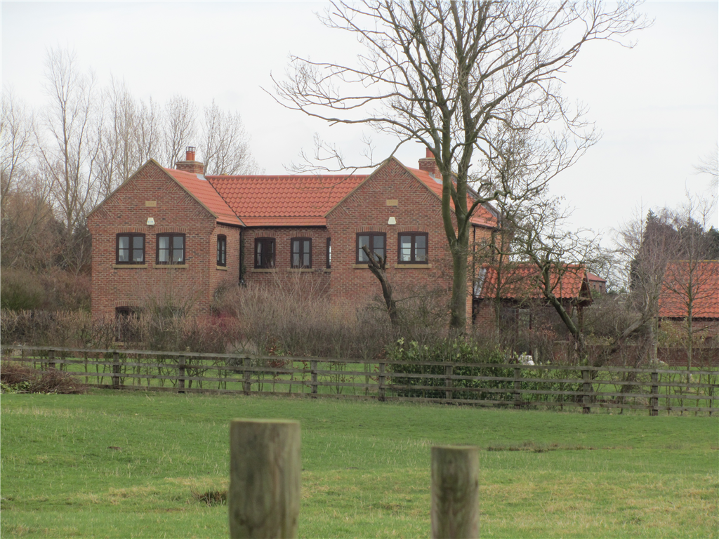 A rural replacement dwelling in handmade brickwork under a pantiled and plain clay tiles pitched roof, adjacent to stables.  Gallery Image